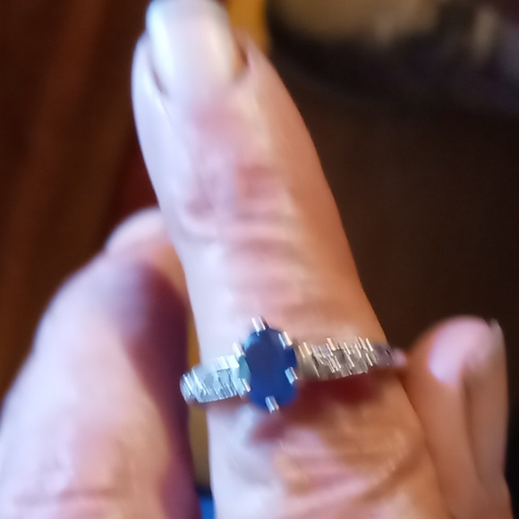 Dark blue sapphire ring set with diamonds on white gold